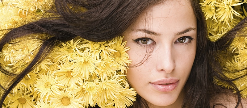 woman's face surrounded by flowers - botox NYC