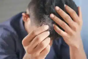 Man touching hair