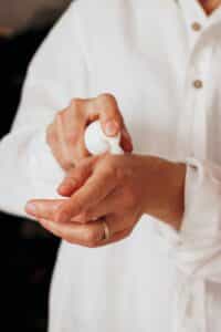 Applying moisturizer to hands