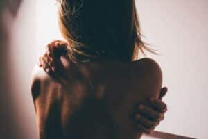 eczema treatment as depicted by a woman scratching her back