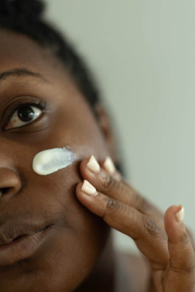 bleaching cream as depicted by woman applying cream to face