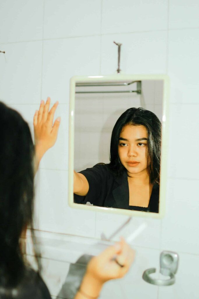 exosomes for hair loss mirror exosomes for hair loss as depicted by a woman looking in the mirror