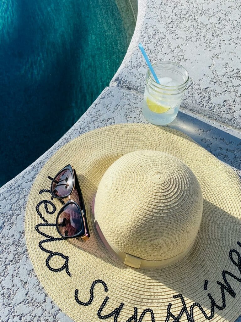 Sun protective clothing as depicted by a sun hat and sunglasses