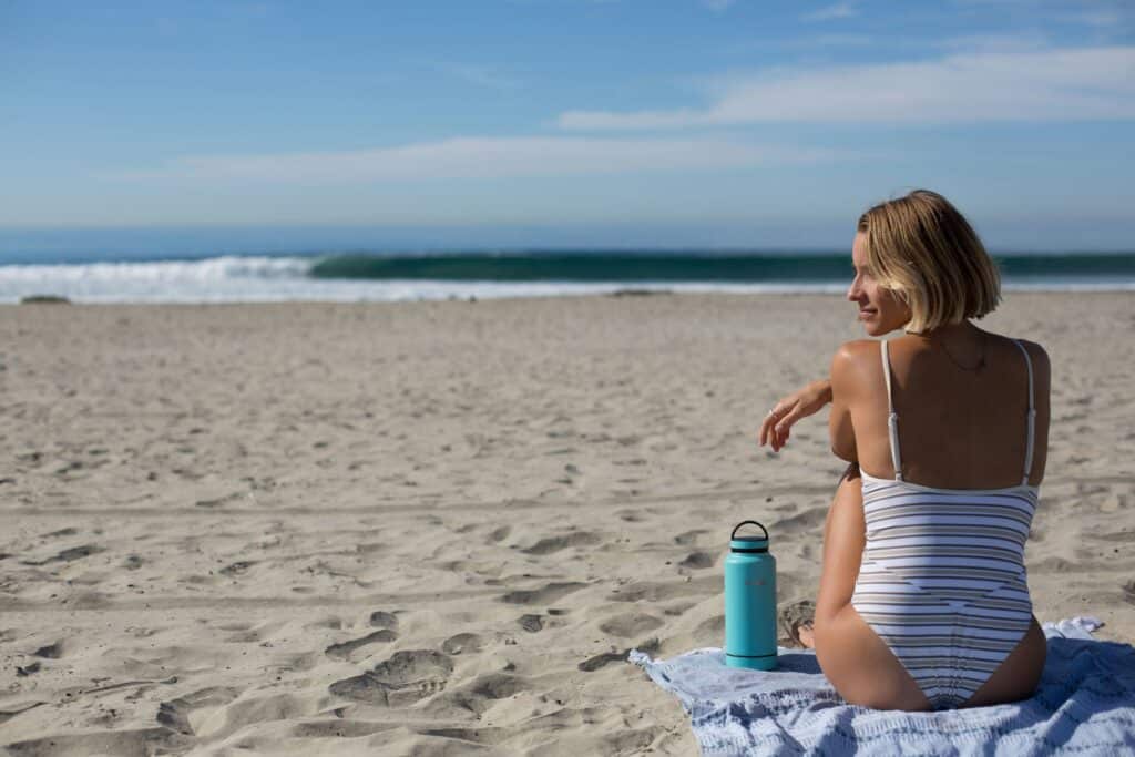 sunscreen for tanning as depicted by woman at beach